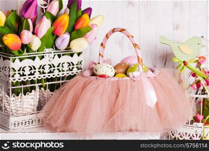 Easter decorations - spring flowers and eggs in tutu basket. Easter decor