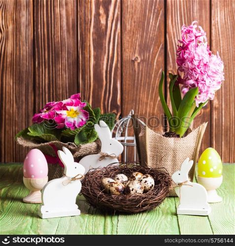 Easter decorations - white shabby chic bunnies and spring flowers. Easter bunnies