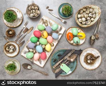 Easter dinner decoration with colored eggs. Festive arrangement. Flat lay