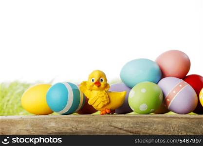 Easter eggs and chickens on green grass with white copy space