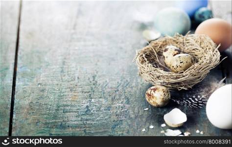 Easter eggs and nest on wooden background - Easter composition