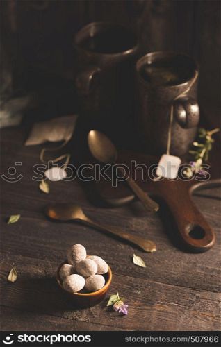 Easter eggs and tea on wooden table top.