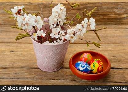 Easter eggs and twigs with flowers of apricot
