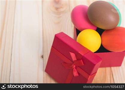 Easter eggs clean in red box gift on wooden background, easter day concept