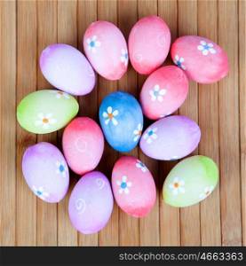 Easter eggs decorated with daisies on a wooden background