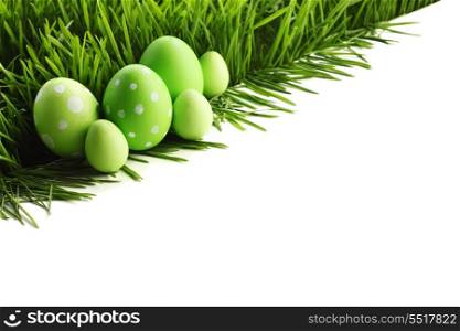 Easter eggs in grass isolated on white background