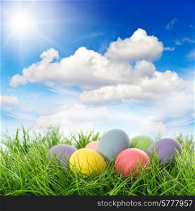 easter eggs in green grass. beautiful sunny blue sky