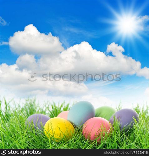 Easter eggs in green grass. Spring landscape. Holidays background