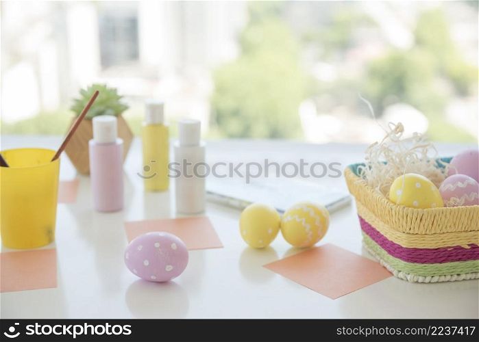 easter eggs near papers colors table