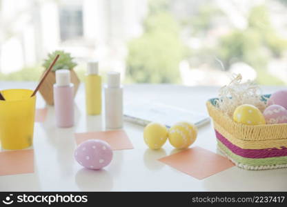 easter eggs near papers colors table