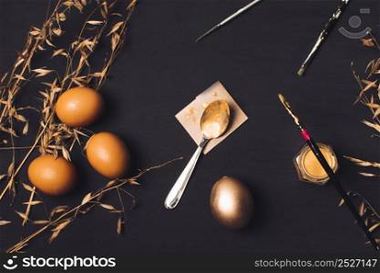 easter eggs near spoon paper brush dye can plants