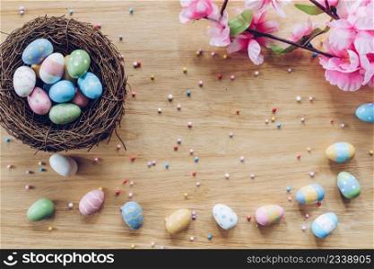 Easter eggs on on wood background top view with natural light. Flat lay style.
