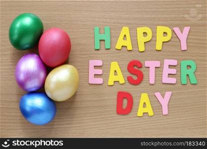 easter eggs on wood background and text Happy Easter Day,Handmade painted for design happy easter day.
