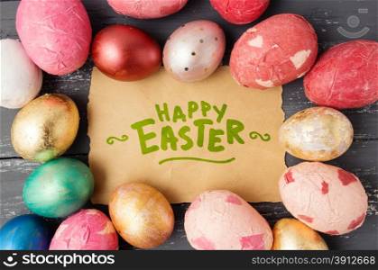 Easter eggs on wooden table with happy easter lettering. Holiday background