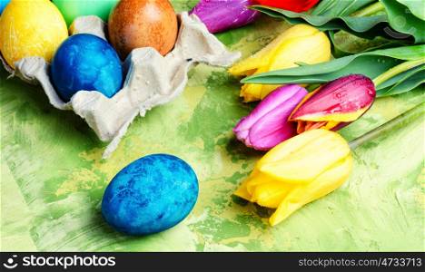 Easter Eggs, Paint and Tulips. symbolic Easter colored egg and colorful paint