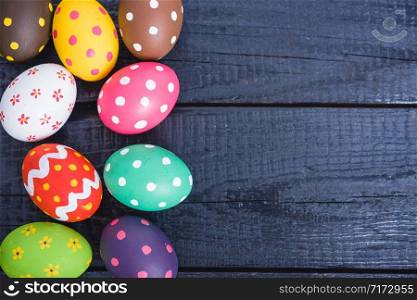 Easter eggs top view on black wooden background and have copy space for use