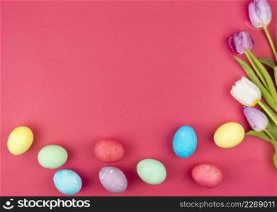 easter eggs with bright tulips red table
