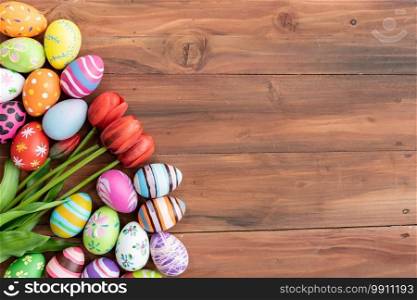 Easter eggs with tulips on wooden background with copy space,Colorful and handmade paint on eggs for easter day traditional in Europe,Easter Day Concept