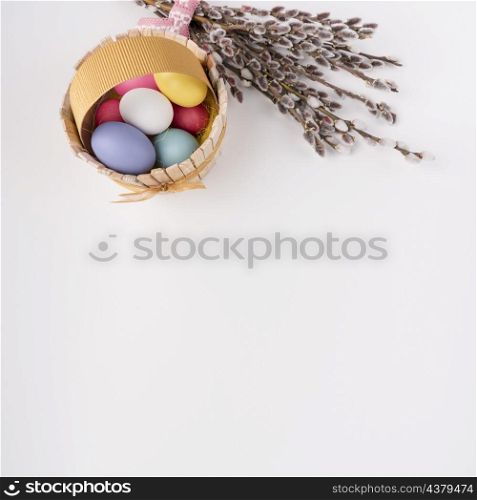 easter eggs wooden basket with willow branches