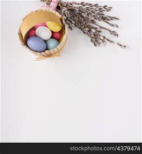 easter eggs wooden basket with willow branches