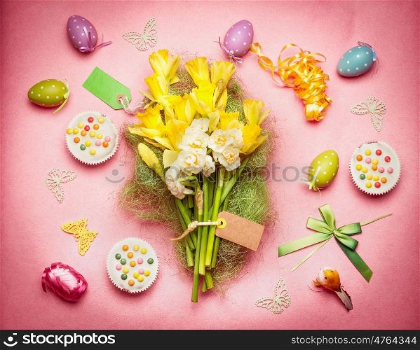 Easter flat lay with spring flowers, eggs and cakes, top view