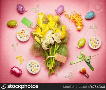 Easter flat lay with spring flowers, eggs and cakes, top view