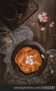 Easter folar with sugar almonds on wooden table top.