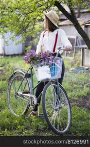 Easter. girl with a bicycle and a rabbit in the garden 