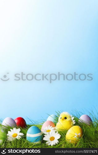 Easter Greeting Card with decorated Easter eggs in the grass and flowers