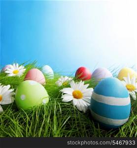 Easter Greeting Card with decorated eggs in the grass and flowers