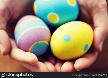 easter, holidays, tradition and object concept - close up of colored easter eggs