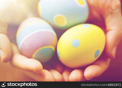 easter, holidays, tradition and object concept - close up of colored easter eggs