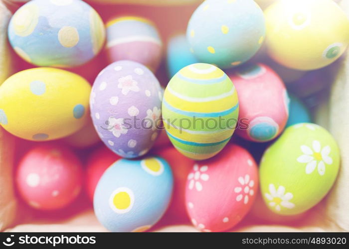 easter, holidays, tradition and object concept - close up of colored easter eggs