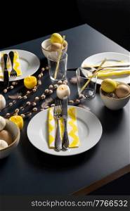 easter, holidays, tradition and object concept - close up of dinner party table serving over black background. close up of easter table serving over black