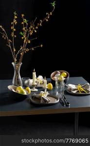 easter, holidays, tradition and object concept - close up of dinner party table serving over black background. close up of easter table serving over black