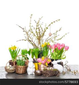 EASTER home decoration with spring flowers, bunny and eggs over white background