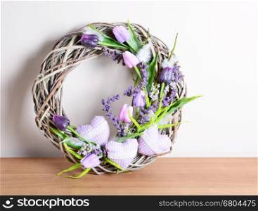 Easter homemade decorated wreath decoration on the table. Homemade arrangement.