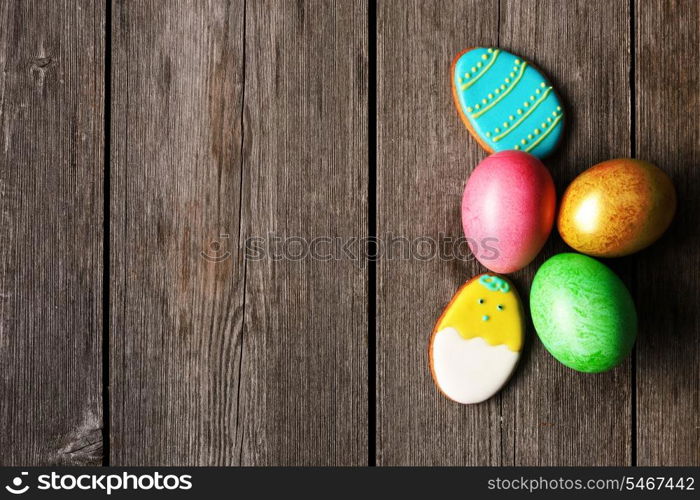 Easter homemade gingerbread cookie and eggs over wooden table