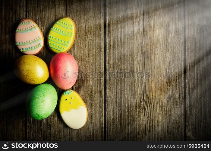 Easter homemade gingerbread cookie and eggs over wooden table