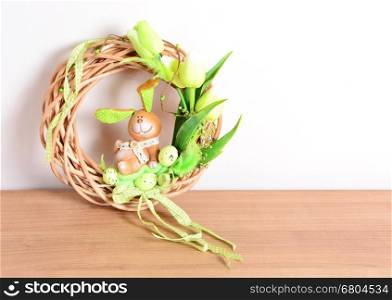 Easter homemade wreath and floral decoration on the table. Homemade arrangement.