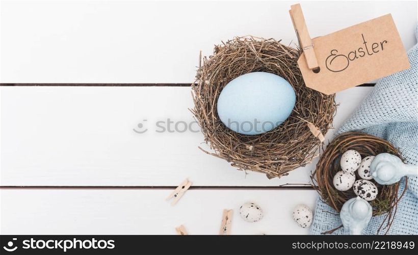 easter inscription with blue egg nest