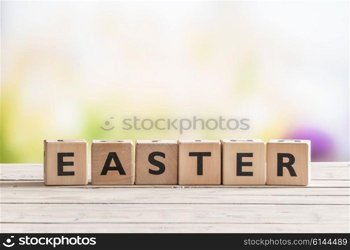 Easter sign on a wooden table in a garden