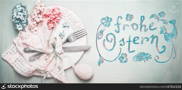 Easter table setting in pastel color with Frohe Ostern text in german