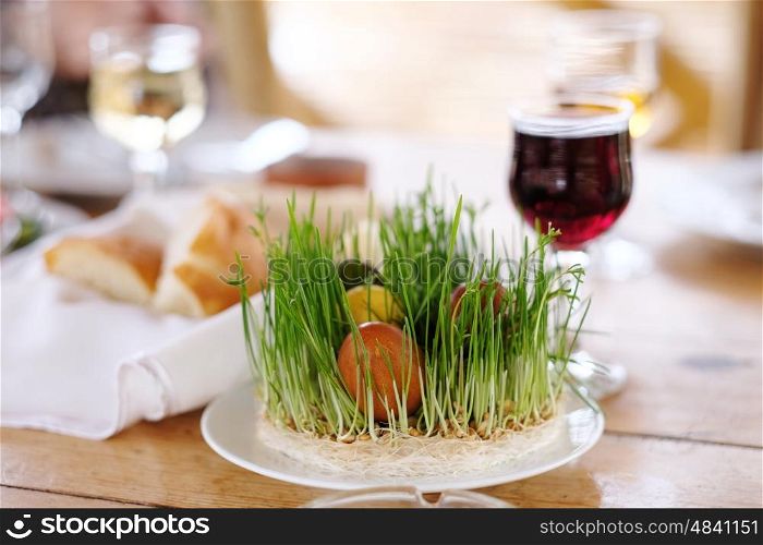 Easter table setting with eggs, wine and decoration