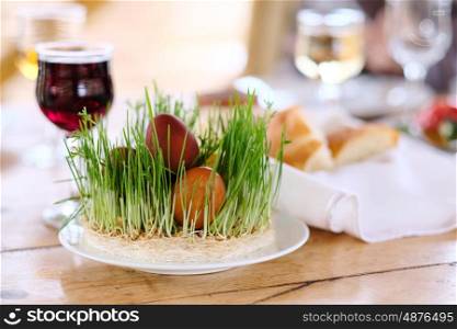 Easter table setting with eggs, wine and decoration