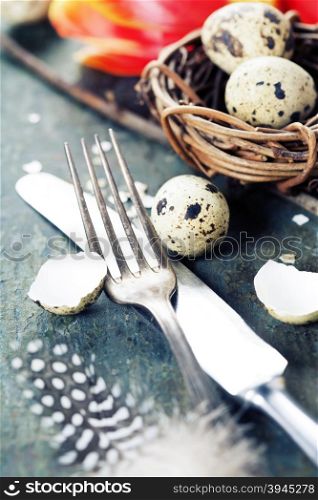 Easter table settings with fresh tulips on vintage wooden background