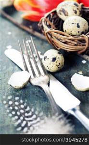Easter table settings with fresh tulips on vintage wooden background
