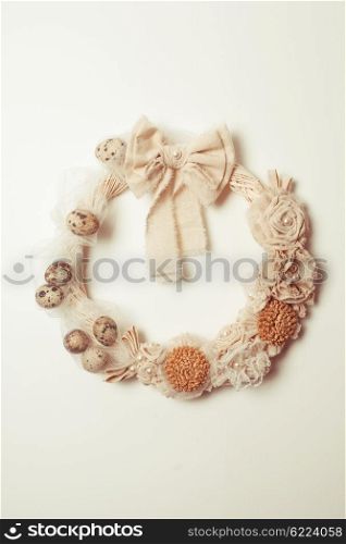 Easter wreath with white bow on the front door isolated on white. Easter wreath on the door
