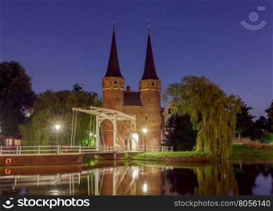 Eastern Gate with the white draw bridge, along Delftse Schie canal at night, Delft, Holland, Netherlands