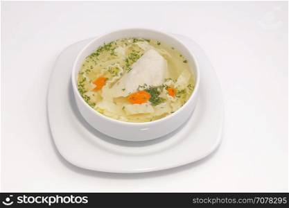 easy chicken soup, close up. light soup with white meat chicken and noodles. View from above